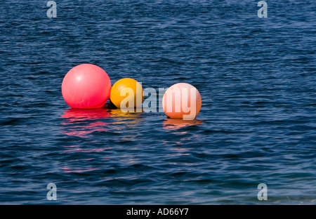 3 coloured buoys on the sea Stock Photo