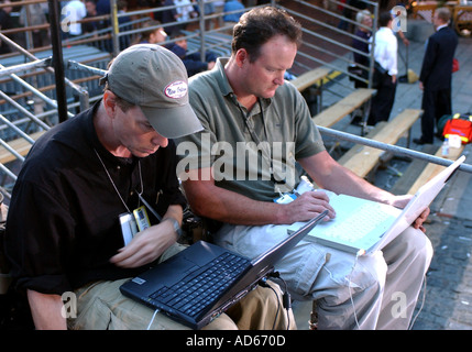 News photographers working on laptops Stock Photo