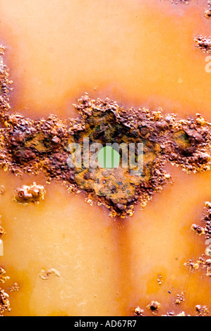 Rusted hole in car door panel abstract Stock Photo