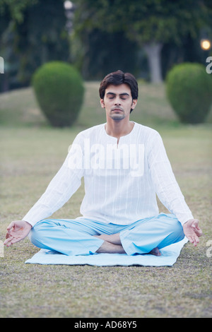 indian man meditating in lotus pose at home Stock Photo - Alamy