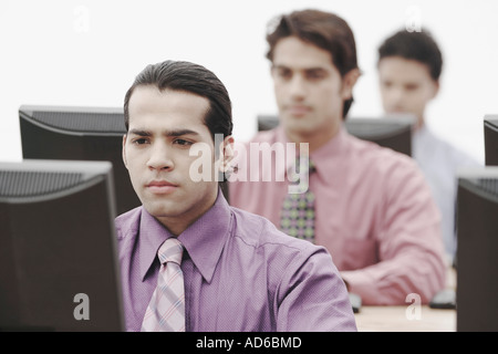 Business executives working on computers in an office Stock Photo