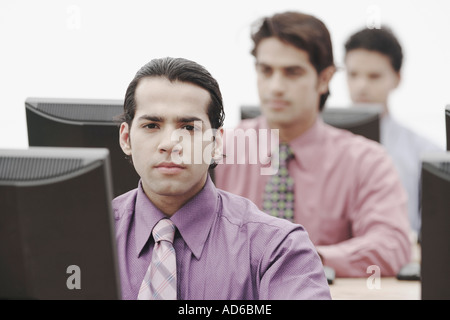 Business executives working on computers in an office Stock Photo