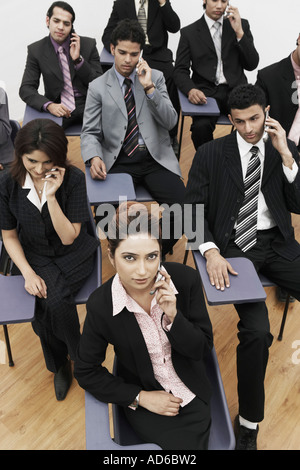 High angle view of business executives talking on mobile phones Stock Photo