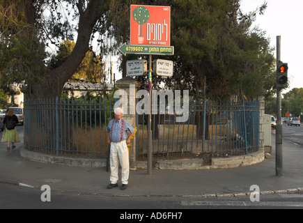 Israel Jerusalem Old Train Station road intersection in front of station with man standing on pavement Stock Photo