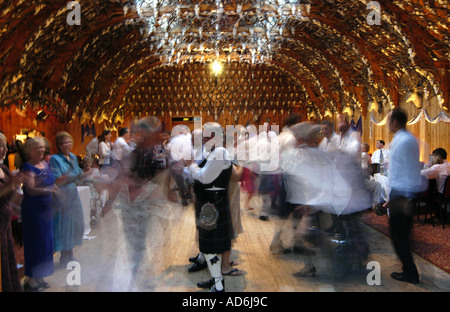 Dancing the Ceilidh reel in the 'Stag Ballroom' at Mar Lodge, Braemar, Cairngorms National Park. Dancers at Scottish wedding dance party. UK Stock Photo