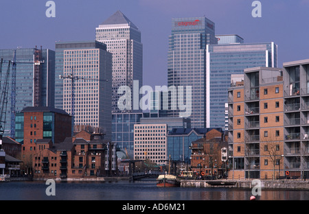 Office towers of Canary Wharf overlooking modern apartments and Dutch barge, Millwall Docks, London Docklands, England Stock Photo