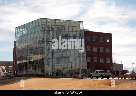 A recently constructed building in the USA shows off modern architecture, complete with a severely leaning glass facade. Stock Photo