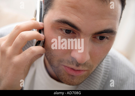 Young man using cell phone, portrait Stock Photo