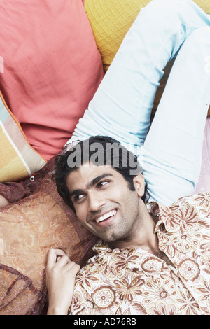 High angle view of a young man lying on a woman's lap Stock Photo