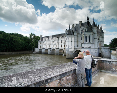 Older couple visiting the famous chateau de Chenonceau castle that is built on a bridge over the river Cher Stock Photo