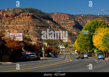 Red rock butte over traffic in downtown Kanab Kane County southern Utah Stock Photo