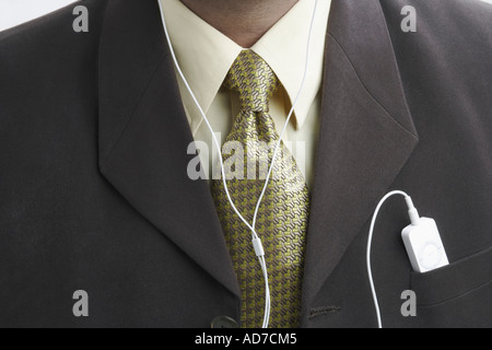 Mid section view of a businessman with an mp3 player in his pocket Stock Photo