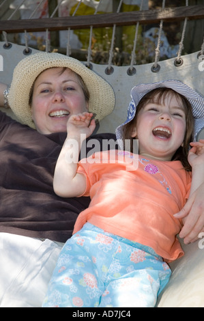 Mother and daughter lying in hammock Stock Photo