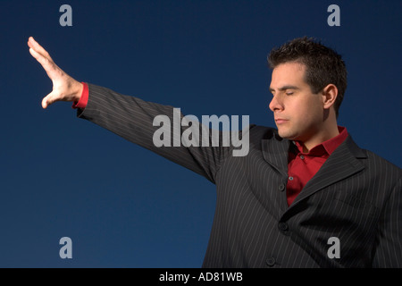 Man with arm outstretched Stock Photo