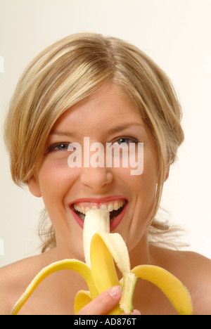 Portrait of Woman eating banana Stock Photo