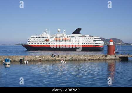 The Hurtigruten coastal steamer leaving Alesund More og Romsdal Norway Stock Photo