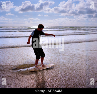 Teenager on a skimboard Woolacombe North Devon, England, UK. Stock Photo