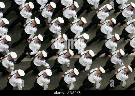 Guardsmen march in step at military parade column Officer Cadets marching symbol symbolism symbolic uniform arms gun rifle cap Stock Photo