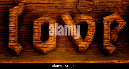 Wooden Carved word Love in a church porch Stock Photo