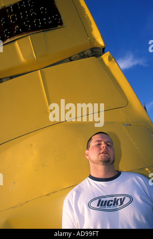 A man leans against a car at Carhenge near Alliance, Nebraska, USA. Stock Photo