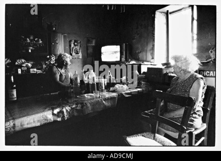 no MR street photography old couple having a meal in front of TV in a poor looking room in Frace Stock Photo