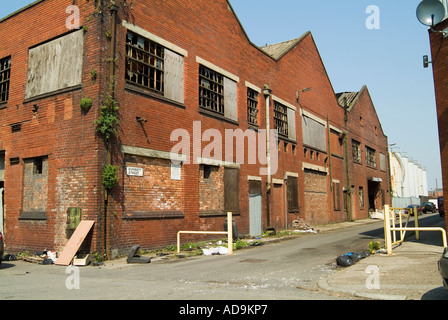 Old buildings adjacent to Liverpool Docks abandoned and falling into disrepair alongside the Dock Road in Liverpool Stock Photo