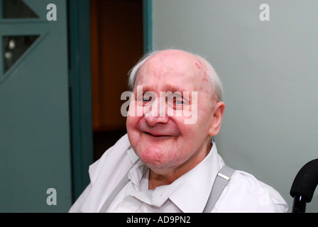 Elderly man in care home for people suffering from dementia at London UK Stock Photo