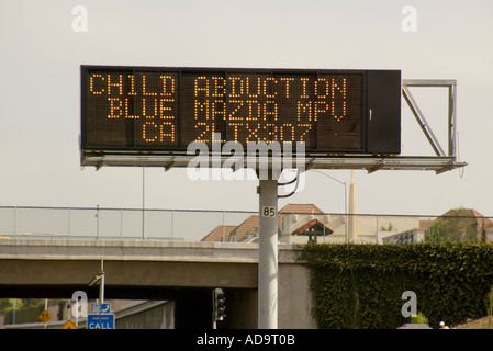 An electronic signboard over the 405 Freeway in Irvine California announces an Amber Alert report of a child abduction Stock Photo