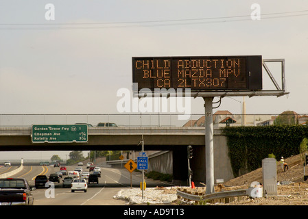 An electronic signboard over the 405 Freeway in Irvine California announces an Amber Alert report of a child abducted Stock Photo