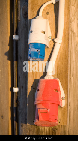 Colorful three-phase current plug points (Finnish) on wall , Finland Stock Photo