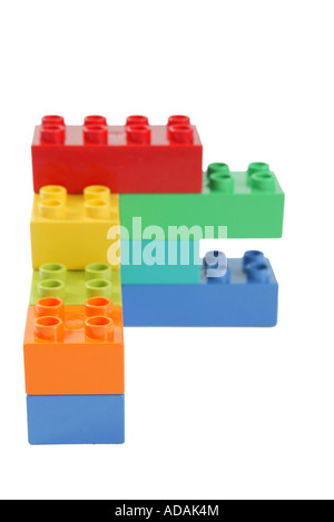 simple construction made from childs lego in studio on clean white surface involving blue orange yellow green and red colors Stock Photo
