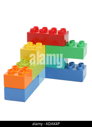 simple upright vertical construction made from childs lego in studio on clean white surface.  blue orange yellow red Stock Photo