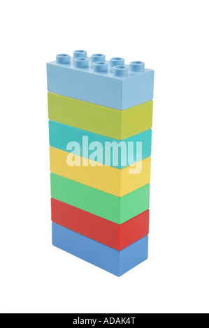simple upright vertical construction made from childs lego in studio on clean white surface.  blue orange yellow red Stock Photo