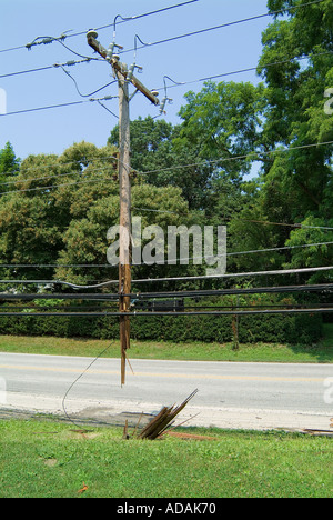 Broken electrical utility pole and power lines due to severe weather ...