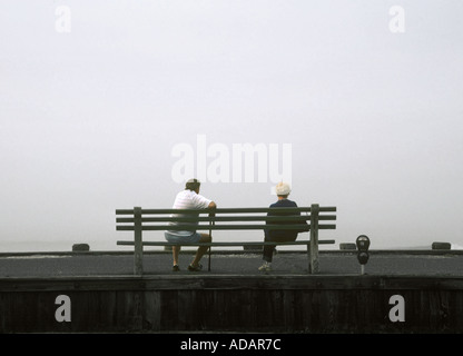 Old Elderly Couple Sitting On Park Bench, Ocean City NJ USA Stock Photo