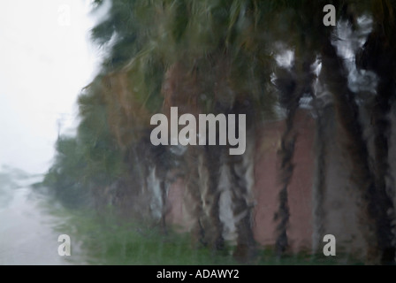 Heavy rain falling on a car windscreen during a rainstorm in Cuba. Stock Photo