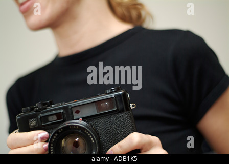 Abstract of Young Caucasian Female using a Classic Rangefinder Camera Stock Photo