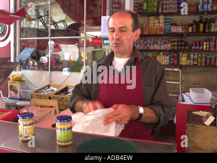 French man selling mustard from market stall, Dijon, France. Stock Photo