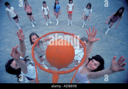 Girls playing netball in a primary school playground in the UK Stock Photo