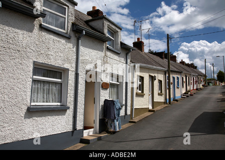 the row seamount row of traditional pebble dashed small fishing cottages on a hill in courtown harbour Stock Photo