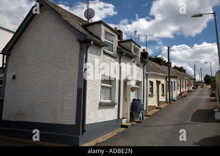 the row seamount row of traditional fishing cottages with gable wall on a hill in courtown harbour Stock Photo