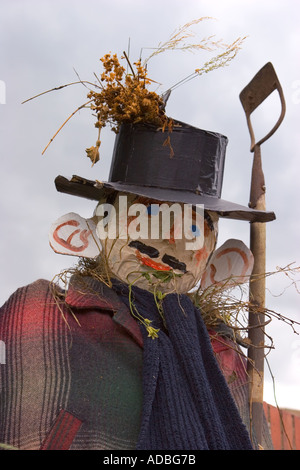 Gardener Scarecrow holding hoe.  "Bus Stop" at summer Hinderwell Summer Gala. waiting for transport, fund raising event in the village. Stock Photo