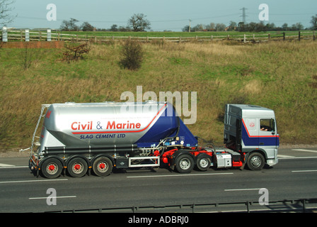 Civil & Marine Slag Cement business logo brand hgv lorry articulated tanker semi-trailer truck driving on M25 motorway road Essex section England UK Stock Photo