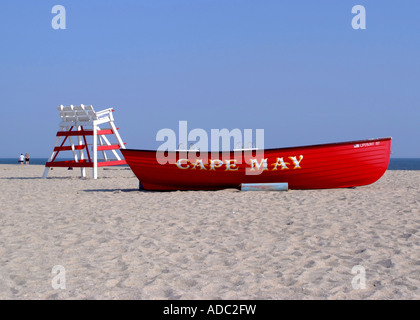 Bright Red Lifeboat and Empty Lifeguards Raised Chair on Beach at Cape May New Jersey United States America Stock Photo