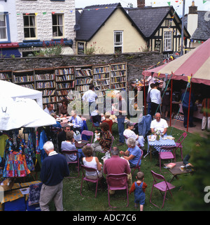 The Honesty bookshop shops shop people visitors eating at cafe restaurant in Hay Castle grounds in 2002 Hay on Wye Wales Great Britain UK KATHY DEWITT Stock Photo