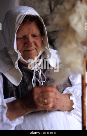 A woman handspinning the wool at the traditional historic recall of the Middle Ages, Sale Marasino, Italy Stock Photo