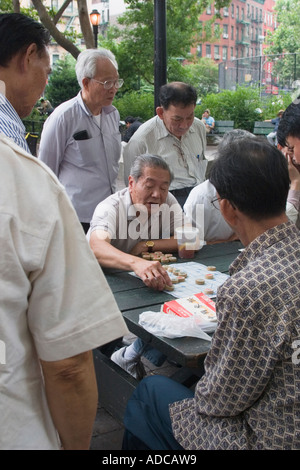 Elder Chinese men playing game in a park in Lower Manhattan New York City New York USA Stock Photo