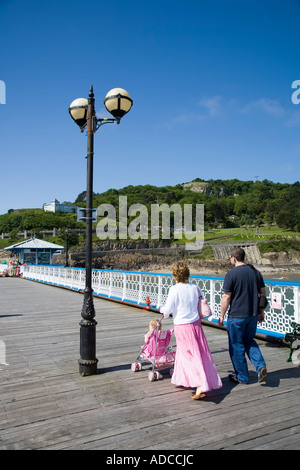 Two adults with child in pushchair on Llandudno pier Wales UK Stock Photo