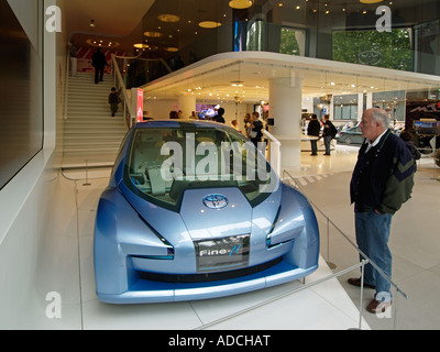 Man looking at futuristic looking Toyota Fine N hybrid concept car in the Toyota flagship showroom in Paris Stock Photo