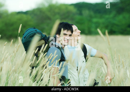 Two hikers standing in field Stock Photo